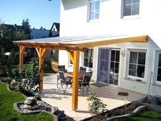 an outside patio with a table and chairs