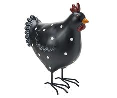 a black and white chicken statue with polka dots on it's head, standing upright