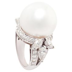 This pearl and diamond ring features a large South Sea pearl of 18mm diameter. The pearl is untreated. It displays a splendid nacre and its natural color and luster have not been enhanced in any way. The pearl is flanked by a leaf-like design with marquise cut and pear shape diamonds for a total of 2.50 carats. The design is complete with a pavé of round diamonds for the weight of approximately 1 carat. All diamonds are of top quality (F/G-VVS). The ring is one-of-a-kind. It was handmade in Ital Cocktail Ring Designs, Diamond Jewelry Set, Marquise Diamond Ring, Diamond Cocktail Ring, Pearl And Diamond Ring, Diamond Fashion Rings, Diamond Cocktail Rings, Sea Pearl, Modern Ring