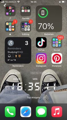 someone is sitting down with their feet up on the floor and there are many different app icons