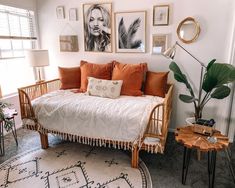 a living room filled with lots of furniture and pictures on the wall above it's couch