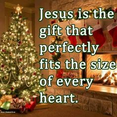 a christmas tree in front of a fireplace with stockings hanging from it and the words jesus is the gift that perfectly fits the size of every heart