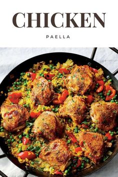 chicken paella with peas and carrots in a skillet on a white surface