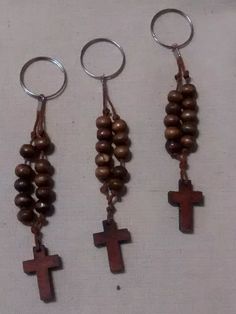 three wooden crosses hanging from metal rings