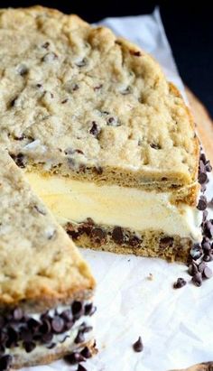 a cake with chocolate chips on it and one slice cut out from the rest of the cake