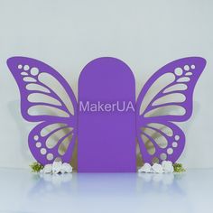 a purple butterfly with the word makerua on it's back and white flowers in front