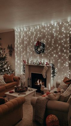 a living room decorated for christmas with white lights on the walls and trees in the corner