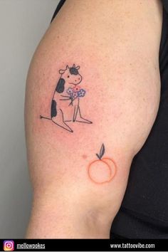 a woman with a cow and apple tattoo on her arm