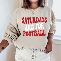 "The \"Saturdays Are For Football Sweatshirt\" is a sturdy and warm sweatshirt bound to keep you warm in the colder months. A pre-shrunk, classic fit sweater that's made with air-jet spun yarn for a soft feel and reduced pilling. Sweatshirt details: * 50% cotton, 50% polyester * Pre-shrunk * Classic fit with no center crease * 1x1 athletic rib knit collar with spandex * Air-jet spun yarn with a soft feel and reduced pilling * Double-needle stitched collar, shoulders, armholes, cuffs, and hem * Model is wearing a size L *If you'd like an oversized fit please order 1-2 sizes larger than your normal size. For any sizing recommendations please message us :) Additional styles & custom orders: All of our designs are listed in several different styles (tees, tanks, hoodies, hats) throughout our s Football Sweatshirts Vinyl, Saturdays Are For Football, Football Crew Neck Sweatshirt, White Long Sleeve Sweatshirt For Weekend, White Crew Neck Sweatshirt For Weekend, Weekend White Crew Neck Sweatshirt, Fall Crew Neck Sweatshirt For Weekends, Crew Neck Sweatshirt For Fall Weekend, Letter Print Sweatshirt For Winter Weekends