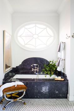 a bath room with a large window and a bench