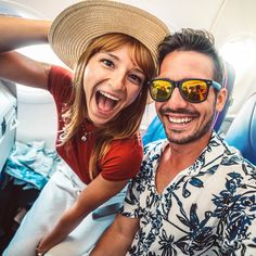 a man and woman wearing sun glasses on an airplane