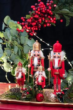 three nutcrackers are standing on a tray