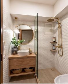 a bathroom with a sink, mirror and shower head in it's corner area