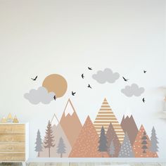 a wall with trees and birds flying in the sky above it, on top of a dresser