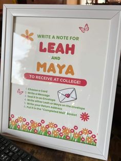 a white framed sign that says write a note for leah and mayoa to receive at college