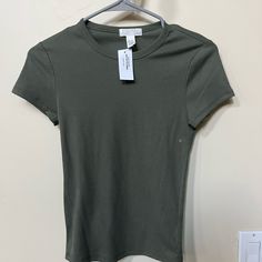 Never Worn, New Olive Green Full Tilt T-Shirt From Tilly’s. Size S Green Everyday Plain Tops, Green Plain Tops For Everyday Wear, Everyday Plain Green Tops, Baby Tee Shirt, Baby Tee Shirts, Baby Graphic Tees, Basic Shorts, Full Tilt, Green Baby