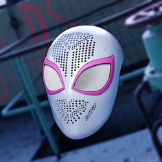 a white mask with pink eyes on top of a table