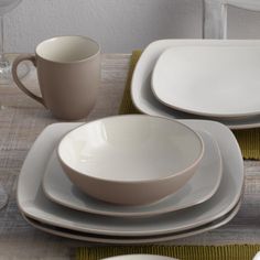 a table set with plates, cups and saucers