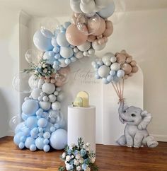 an elephant balloon arch with blue and white balloons