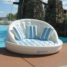 an inflatable chair sitting next to a swimming pool