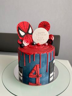 a spiderman themed birthday cake on a table