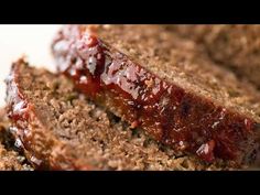 sliced meatloaf on a white plate with ketchup