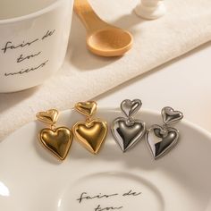 Two-Tone Heartbeats "Bicolor Heart Whispers - Gold and Silver Layered Heart Stud Earrings" represent a perfect melding of taste and fashion with their distinctive bicolor design. Capturing the timeless beauty of the heart shape, the combination of gold and silver hues allows the wearer to shine distinctively. Specifications: Dimensions: 3.22cm Long, 2.03cm Wide Materials: 925 Silver Color: Silver, Gold Opal Pendant Necklace, 18k Gold Earrings, Vintage Punk, Heart Dangle Earrings, Heart Stud Earrings, Heart Shaped Earrings, Heart Drop Earrings, Earring Display, Initial Bracelet