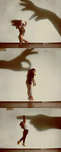 the shadow of a person's hand is cast on a wall as if they were dancing