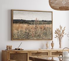 a painting hanging on the wall above a dining room table