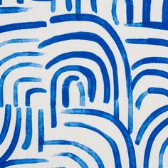 an abstract blue and white background with wavy lines in the shape of spirals on fabric