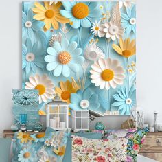 a bed with blue and yellow flowers on the wall next to a dresser in a bedroom