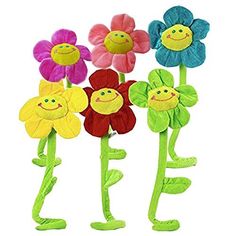 four colorful flowers with smiley faces on them