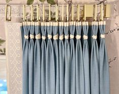 blue curtains with white trim hanging on the wall