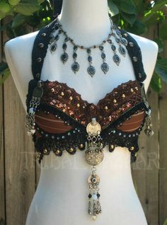 a white mannequin wearing a brown and black bra with chains on it's chest