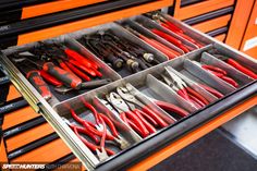 a drawer filled with lots of tools on top of a table