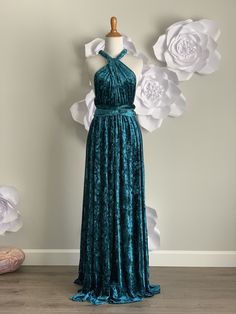 a dress on a mannequin with flowers in the background