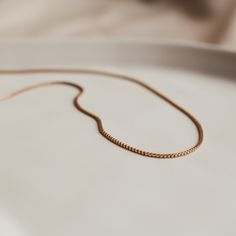 Add a touch of sophistication with our sleek Aria box chain necklace. Super versatile this chain is perfect for the single necklace minimal but elegant look or add to your necklace stack for a bit more texture. Modern Everyday Necklace With Curb Chain, Everyday Minimalist Necklace With Curb Chain, Modern Curb Chain Necklace For Everyday, Modern Everyday Curb Chain Necklace, Rose Gold Minimalist Cable Chain Necklace, Minimalist Rose Gold Cable Chain Necklace, Timeless Delicate Chain Necklace In Rose Gold, Minimalist Rose Gold Chain Necklace, Minimalist Delicate Chain Necklace As Gift