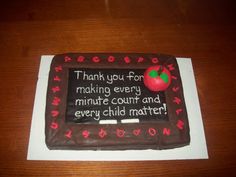 a cake with writing on it sitting on top of a table