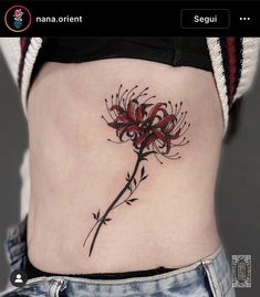 a woman's stomach with a flower tattoo on it