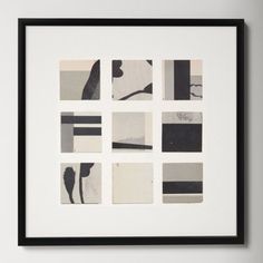 a black and white photo hanging on the wall next to a framed artwork piece in a frame