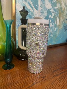 there is a coffee cup that has been decorated with jewels