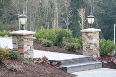 an entrance to a park with stone pillars and steps