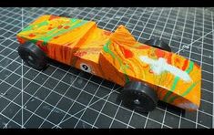 a toy car made out of paper on a table