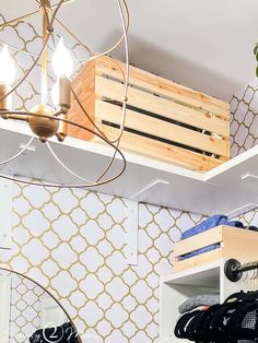 a closet with shelves, clothes and shoes on top of the shelves in front of a mirror