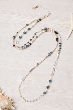 This transitional piece offers versatility in wear. It is a collage featuring fresh water pearl, kyanite, and iolite, with beading and gemstone chains. The piece can be worn as a single necklace or wrapped around your wrist and worn as a bracelet. However, the necklace can also be clasped to another piece in this collection (SEA043C) to have a long collage necklace that can be worn wrapped at the neck (see last two photos).  Sterling silver (lead and nickel free) Fresh Water Pearl, Kyanite, Iolite 37.25-39.25", adjustable with sterling silver lobster claw clasp We hand select our natural materials, thus there may be slight variations in color and/or size that will not detract from the overall aesthetic Our unique handcrafted designer jewelry for women is made in America, with each design c Collage Necklace, Single Necklace, Designer Handmade Jewellery, Fresh Water Pearl, Beaded Jewelry Patterns, A Collage, I Love Jewelry, Jewelry Patterns, Made In America