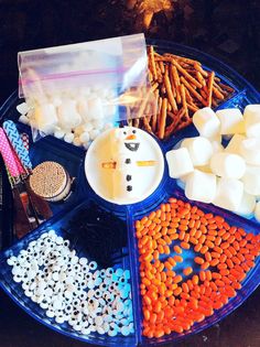 an assortment of marshmallows and pretzels arranged in a circle on a plate