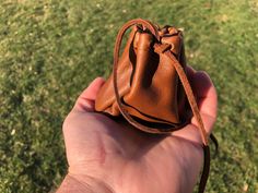 "This is a handmade leather coin pouch crafted for those who seek simplicity in their lives. This (Mini) minimalistic pouch can fit perfectly in your pocket, backpack, purse, etc. Measurements: 3\" X 3\" X 3\" The high quality soft leather from Wisconsin creates the most unique coin pouch as close as it can get from the ones crafted in ancient times. Use this unique pouch to carry dried fruits, nuts, coins, stones... ✅Handmade ✅100% Genuine leather ✅Dense material that will last for ages! ✅Easy Medieval Handmade Pouch For Gift, Medieval Style Handmade Pouch For Gift, Medieval Handmade Pouch As Gift, Medieval Handmade Pouch For Everyday Use, Medieval Style Handmade Pouch For Everyday Use, Unique Pouch, Pouch Craft, Coin Pouch, The Pouch