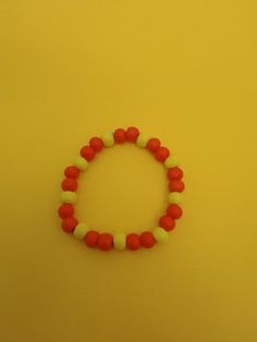 Beaded yellow and red bracelet with elastic string 8.5 inches long Yellow Wooden Bead Bracelets, Yellow Bracelet With Round Wooden Beads, Yellow Wooden Beads Bracelet, Adjustable Yellow Wooden Beaded Bracelets, Adjustable Yellow Bracelet With Wooden Beads, Red Stretch Bracelet With Large Beads, Red Wooden Beads Bracelets As Gift, Adjustable Red Beaded Bracelets With Wooden Beads, Red Wooden Bead Bracelets