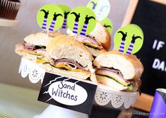 sandwiches are stacked on top of each other in a cupcake holder at a birthday party