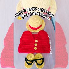 a crocheted teddy bear wearing a red sweater and hat with sunglasses on it